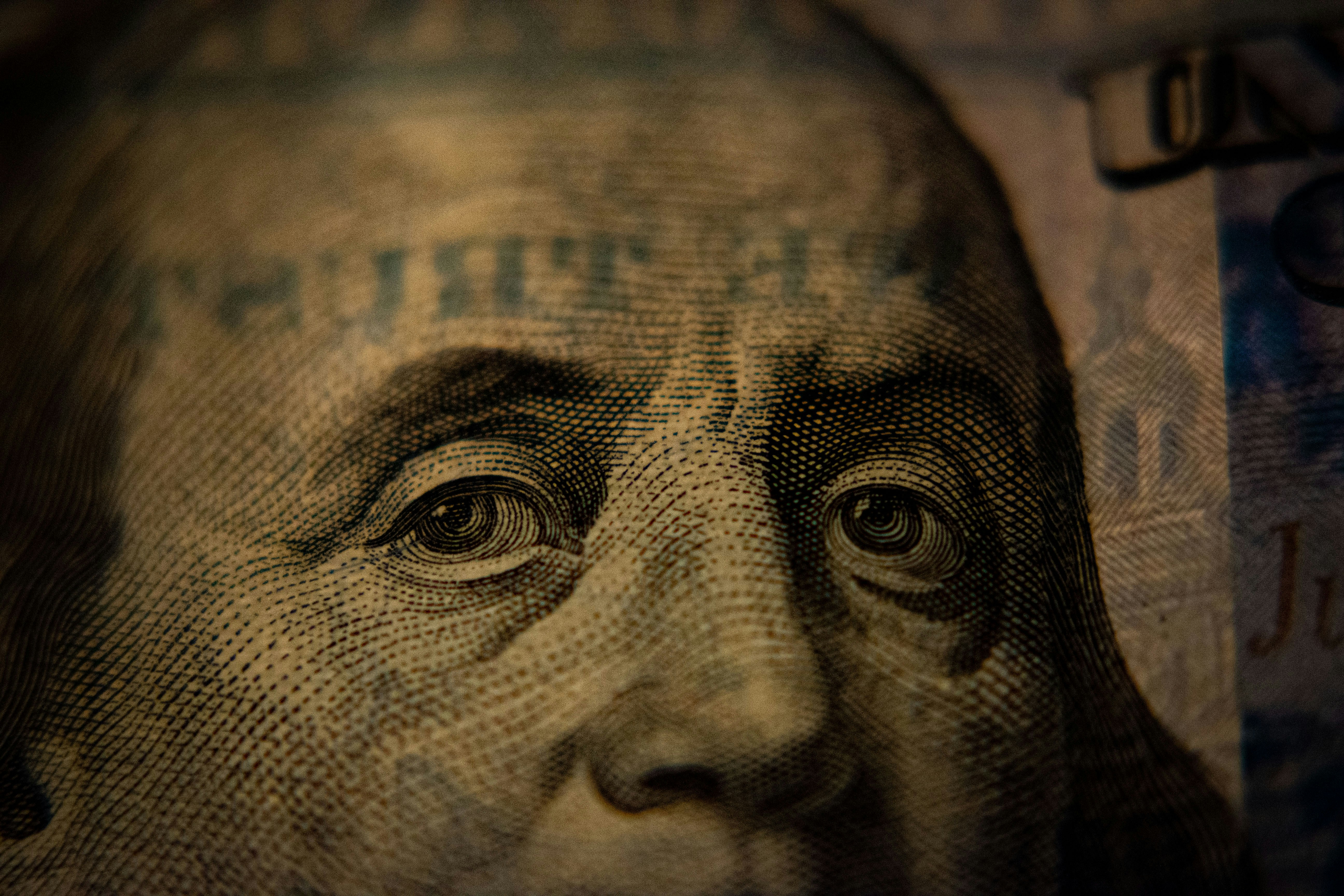 Close-up of a $100 bill representing the gap between what your product is worth and what you are charging for it