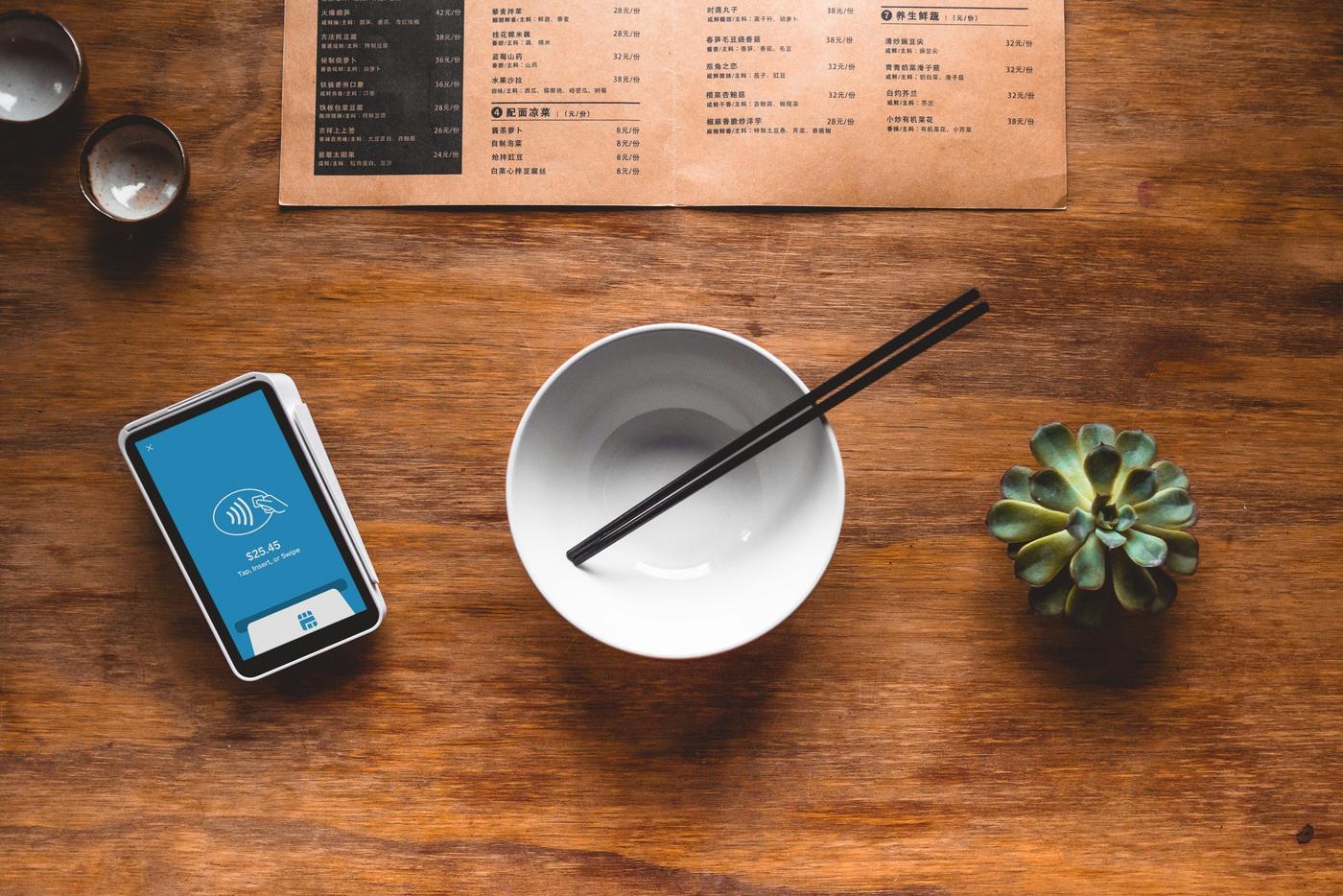 Card payment terminal on a cafe table
