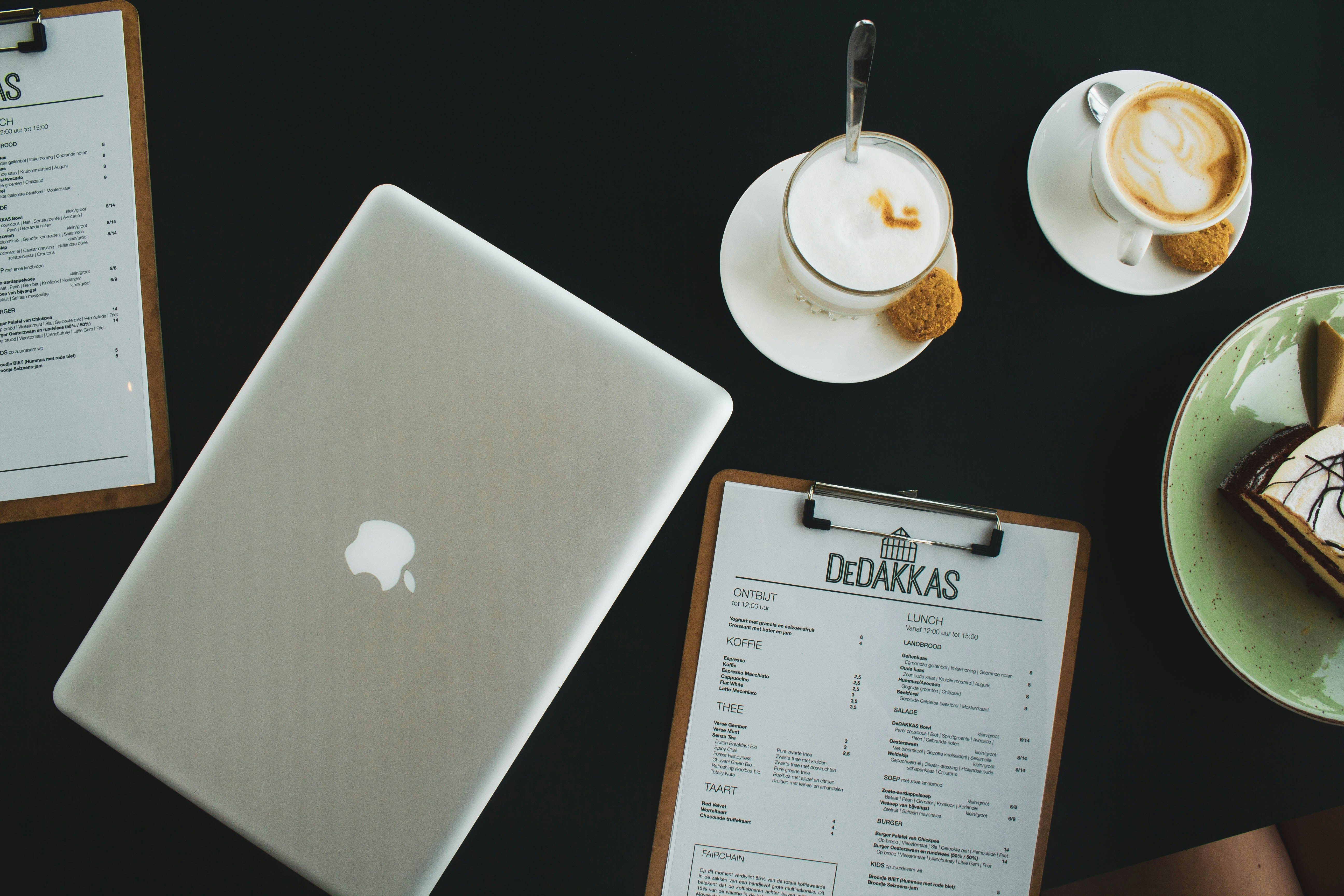 Laptop, coffee and clipboards on an owner's desk