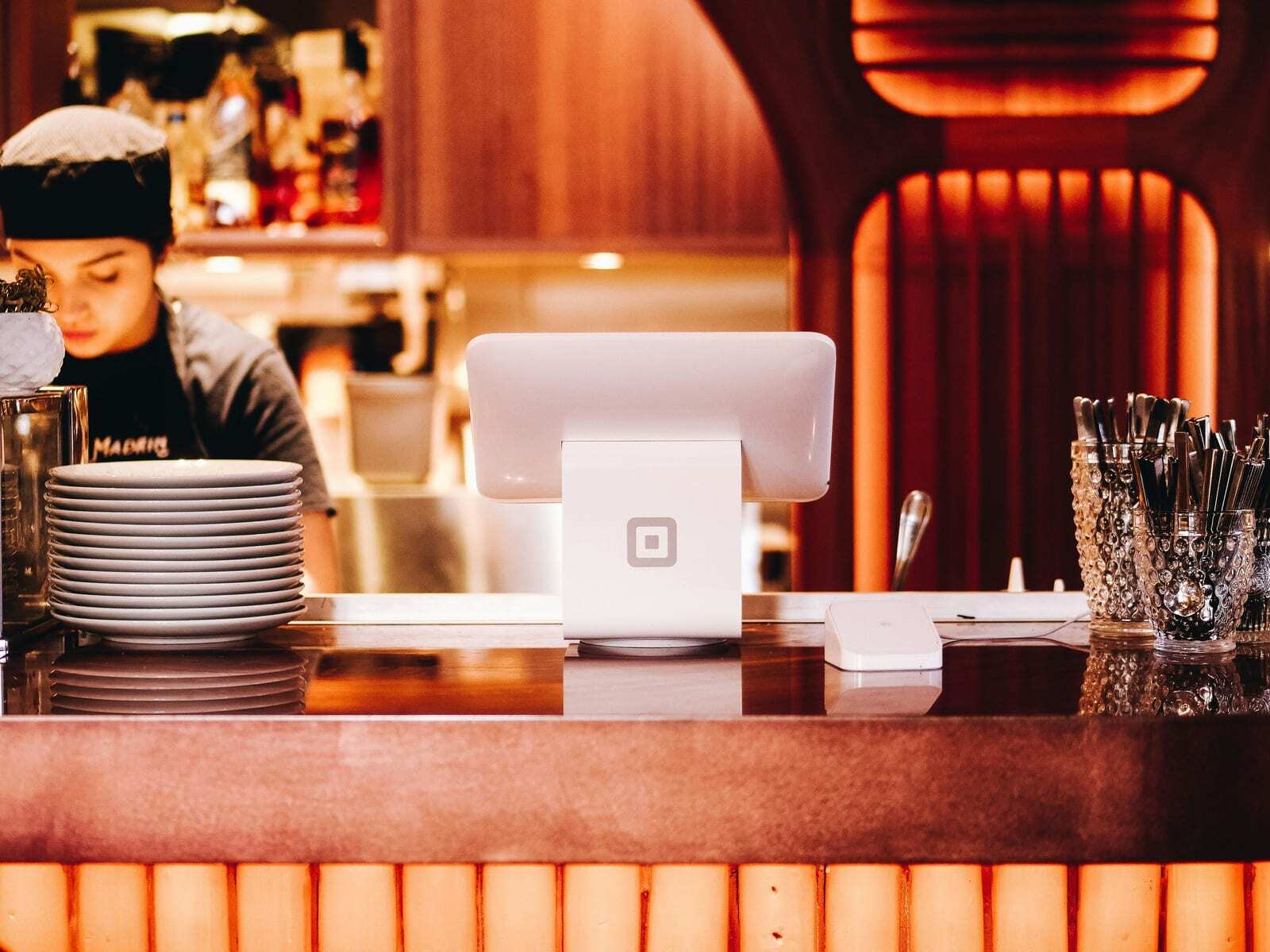 Restaurant bar counter with Square point-of-sale terminal representing the revenue numbers that can hide poor underlying business decisions