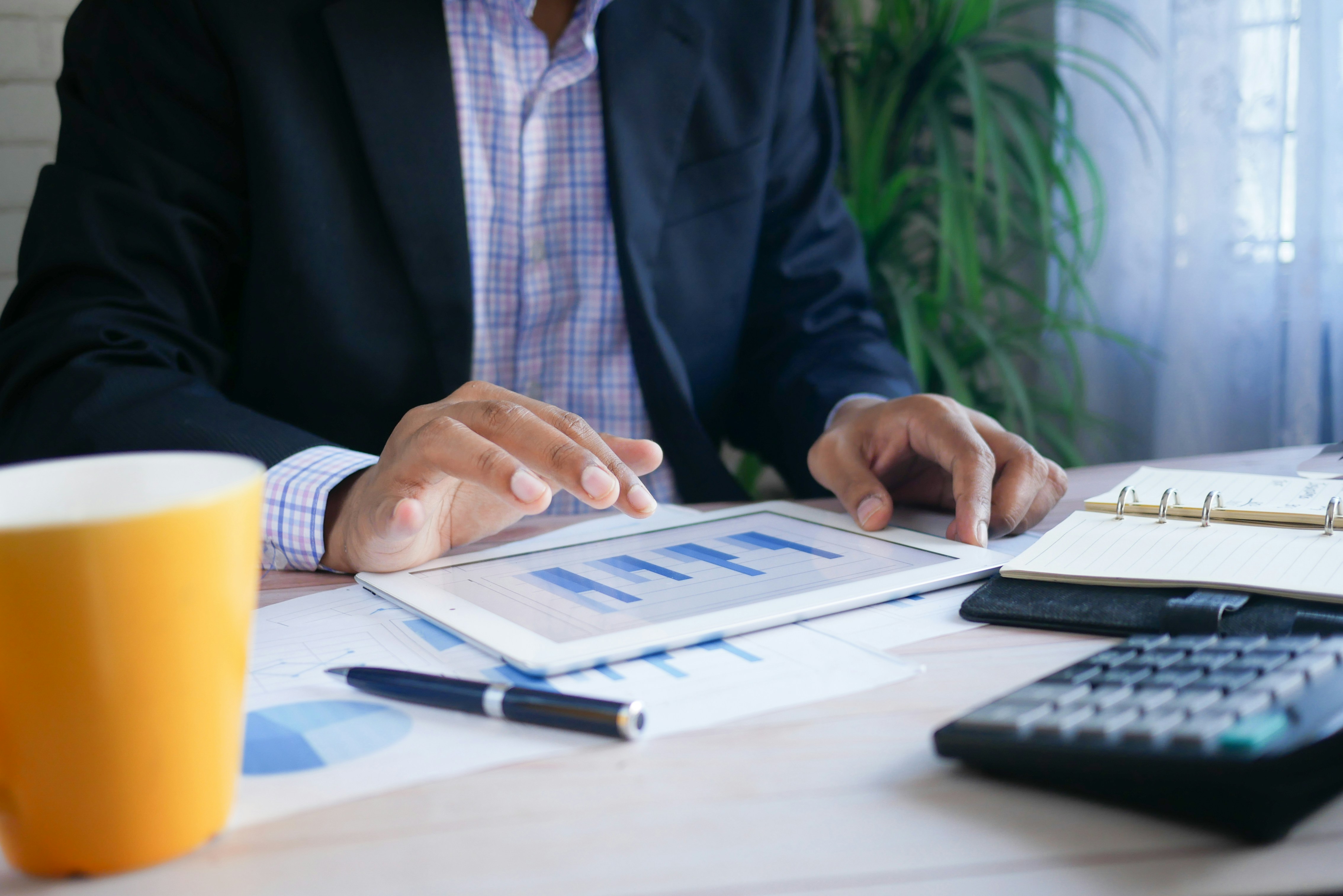 Business professional analyzing retention metrics on a tablet, representing the clarity that comes from measuring what you keep versus what you lose
